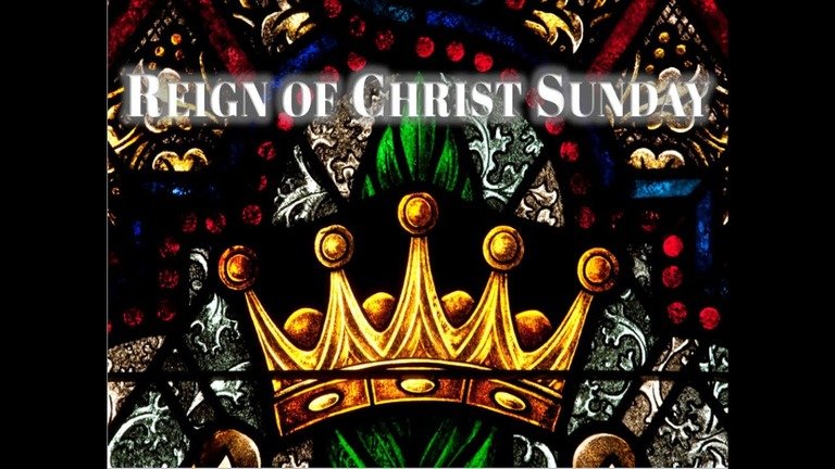 Stained glass image of a golden crown with the text "Reign of Christ Sunday."